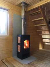 Популярный камин с дровницей Сибирь 8 в интерьере фото в Слониме