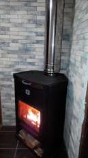 Стальной недорогой камин Теплодар ОВ-120 (угловой) фото в интерьере в Слониме